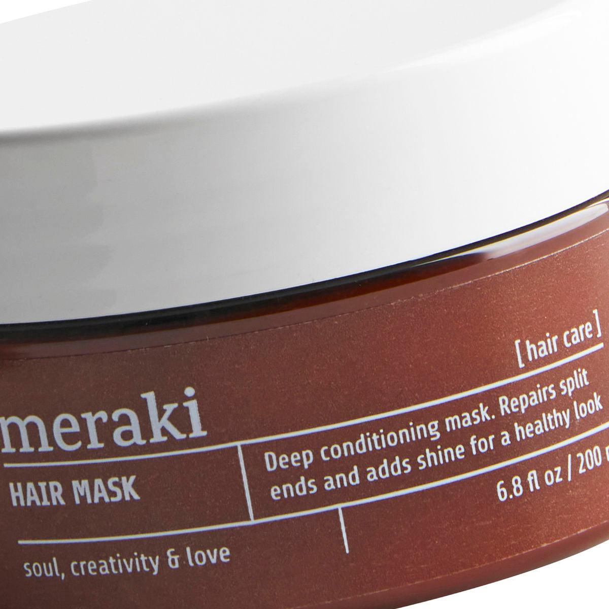 A deep conditioning hair mask in a round tub, brown with a white lid.